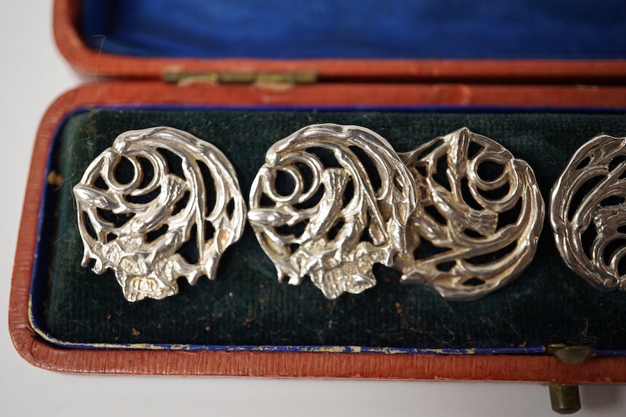 An Edwardian cased set of 6 Art Nouveau silver buttons, cast with stylised scrolling flowers, James Deakin & Sons, Chester 1904, 20mm. Condition - good